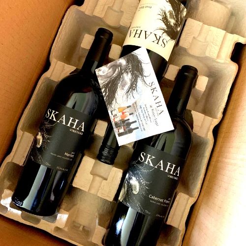 Three bottles of Skaha Vineyard wine in a wine club box 